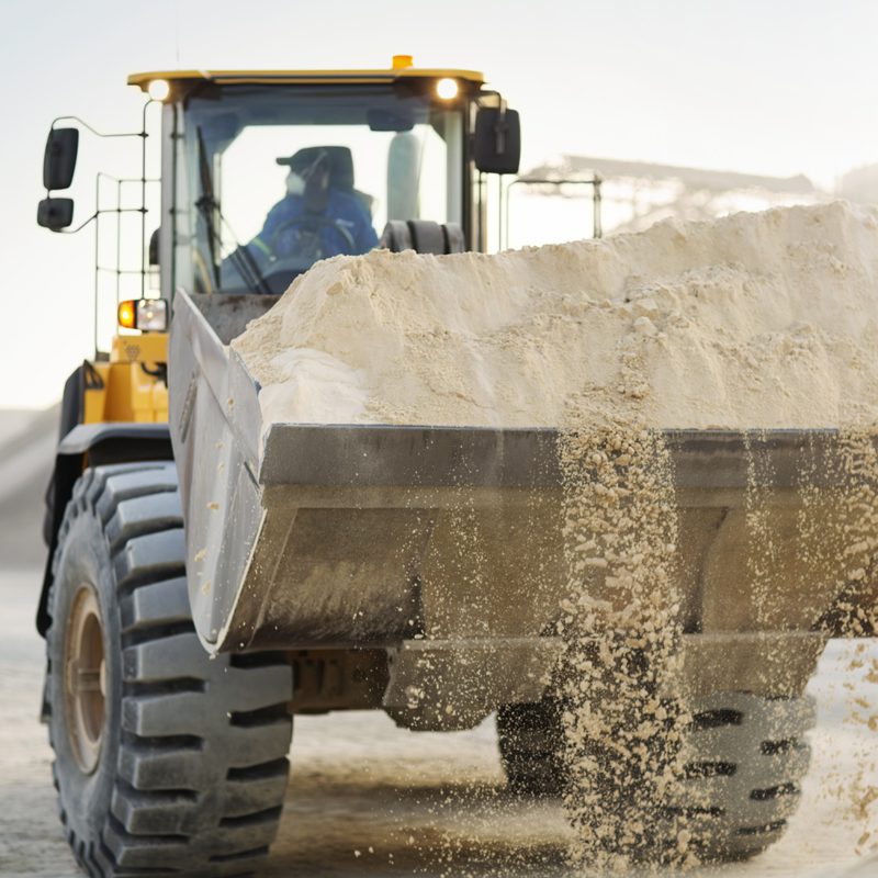 Contractors Resource | Early Branch, SC | Man driving a tractor filled with sand