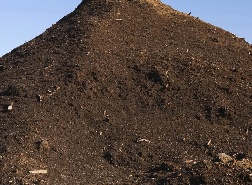 Contractors Resource | Early Branch, SC | Top soil hill against a blue sky